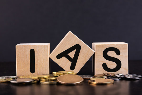 IAS - acronym from wooden blocks with letters, abbreviation IAS  International Accounting Standards concept, coins background Stock Photo |  Adobe Stock