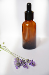 Obraz na płótnie Canvas Aromatherapy oil and lavender, lavender spa, Wellness with lavender, lavender syrup on a wooden white background