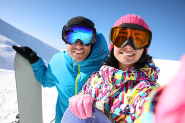 Couple taking selfie on hill. Winter vacation