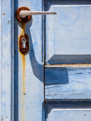 rusty lock of blue wooden door. Santorini island. Cyclades, Greece