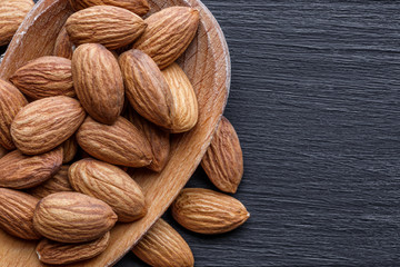 Organic almond nuts as background, top view. Healthy snack. For vegetarians.Space for text