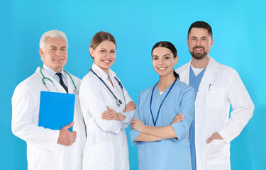 Fototapeta premium Group of doctors against blue background. Medical service
