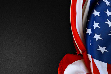 American flag folded on a black background