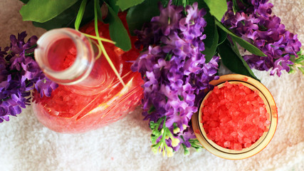 Red sea salt and purple flowers top view, beauty and care