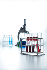 Row of blood sample in test tube selective focus. Lab glassware science equipment at laboratory. Science laboratory research, pharmaceutical, scientific research  and development concept.