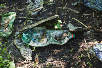 earth pollution with plastic waste and water bottles, spilled garbage on the ground