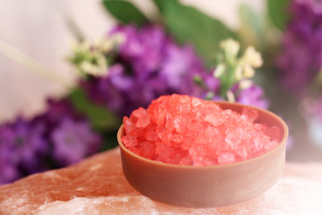 Red sea salt and purple flowers background