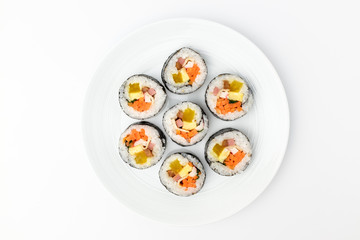 Gimbap with vegetables on white background