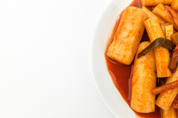 Tteokbokki with soup on white background
