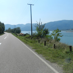 Landscape, path along the lake with mountains in the background
