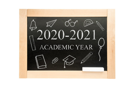 Blackboard with the text academic year 2020 2021 and drawings with school supplies. School Board in wooden frame isolated on white background.