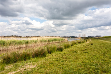 Fototapeta na wymiar Landscape with blue sky and clouds between Ridderkerk and H.I. Ambacht . The Netherlands