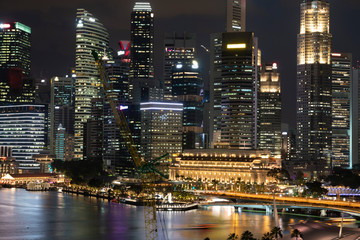 Naklejka premium Picturesque panoramic view of Singapore city at night time. Financial and trading center hub in Asia region. Concept of success. Modern buildings in high-tech world.