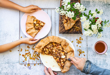Family eat breakfast together. Baked apple pie, cake, or tart sweet vegan dessert on plate.