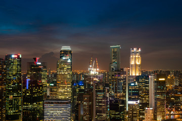Fototapeta premium Picturesque panoramic view of Singapore city at night time. Financial and trading center hub in Asia region. Concept of success. Modern buildings in high-tech world.