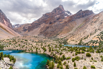 The beautiful mountain trekking road with clear blue sky and rocky hills and the view of Alaudin...