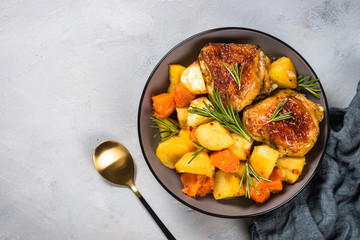 Baked chicken with vegetables top view.