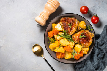 Baked chicken with vegetables top view.