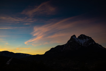 Peak of Pedraforca in Catalonia snowed with clear sky during sunset