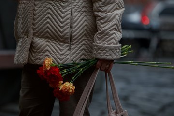 woman holding carnations