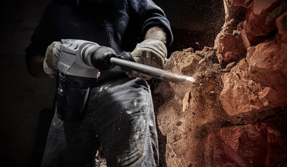 Construction Worker with Powerful Hammer Drill