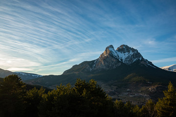 Peak of Pedraforca in Catalonia snowed with clear sky during sunset