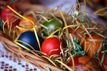 Colorful Easter eggs in a bowl on the table. Beautiful holiday decoration.
