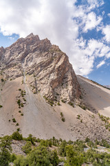 The beautiful mountain trekking road with clear blue sky and rocky hills in Fann mountains in Tajikistan