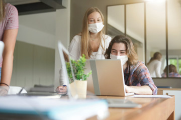 group of students working wearing masks