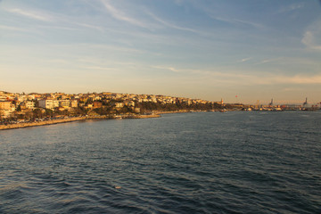 Fototapeta premium View of the Uskudar district and port of Istanbul from the Bosphorus at sunset. Turkey