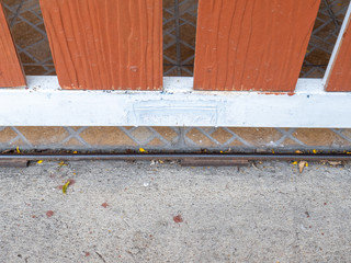 Metal gate with a brown woodboard