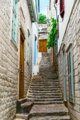 Fototapeta na wymiar Hydra, Attica / Greece - June 6, 2010: Beautiful alley with stairs in the old historic village