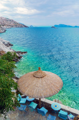 Hydra, Attica / Greece - June 6, 2010: Bar terraces facing the turquoise waters of the Aegean Sea