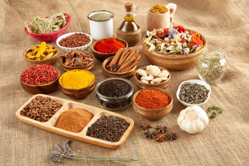 Various spices and herbs as a background.
