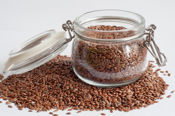 flax seeds in a glass jar. scattered flax seeds