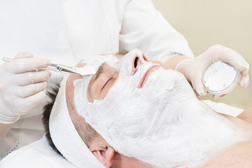 Man in the mask cosmetic procedure in spa salon 
