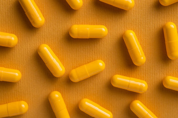 Yellow vitamin pills in capsule