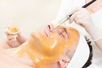 Man in the mask cosmetic procedure in spa salon 