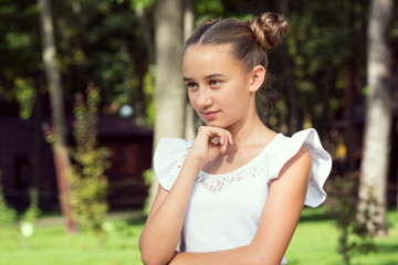 portrait of a young girl in a summer park.
