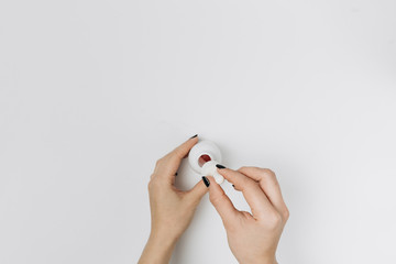 Cropped shot of woman with hands and bottle of lotion isolated on whitе
