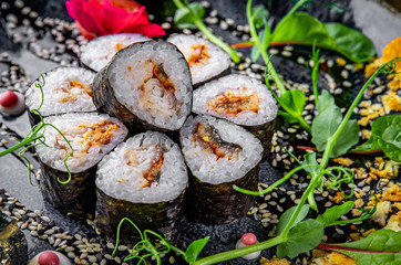 sushi roll with eel and rice in plate