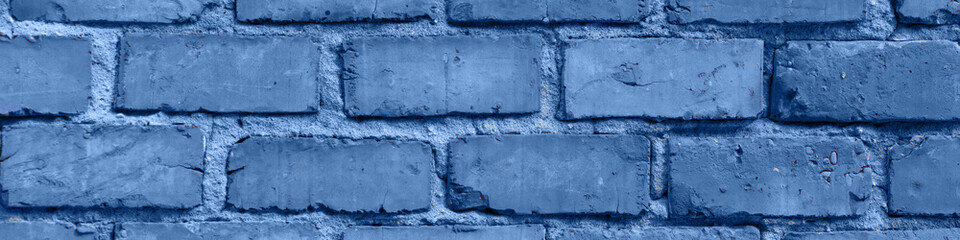 Old red brick wall in Italy. Faded red color, a bit dirty. Copy space for text. Toned in modern blue color 2020. Banner