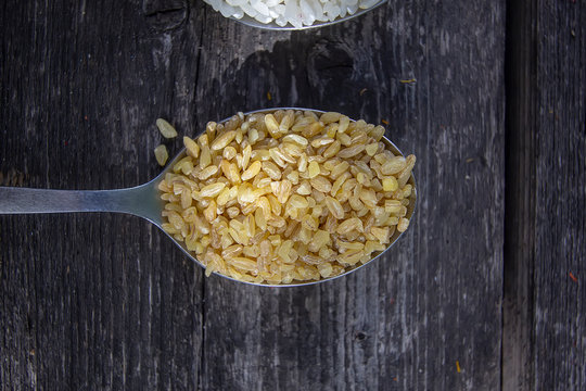 bulgur in a tablespoon on a wooden background