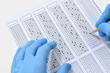 Student taking multiple choice exam during Coronavirus pandemic. 