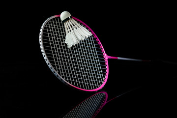 Badminton racket. Professional sport equipment isolated on black studio background. Concept of sport, leadership, competition, healthy lifestyle in motion and action, training. Close up, copyspace.