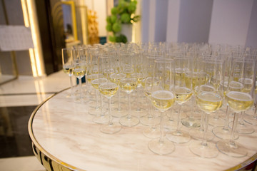 white table with glasses with champagne