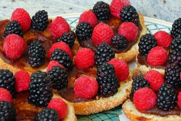 Raspberry and blackberry tarts on apple donuts