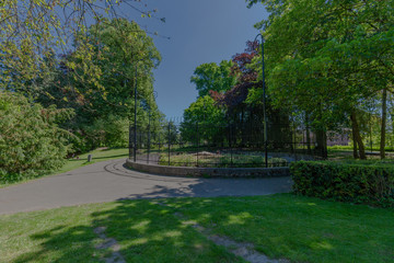 Former bear cage in the city park of Maastricht, now in use to exhibit extinct animals during a warm sunny day in early May