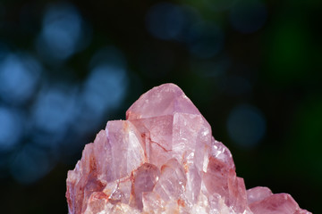 Huge amethyst among nature and many trees