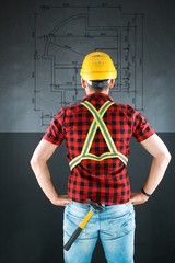 Construction worker with yellow crash helmet. Builder  on black baground.  He views the building...